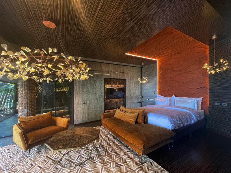 Modern bedroom with a bed, sofa, and decorative lighting fixtures, Makanda by the Sea, Costa Rica, Manuel Antonio luxury suite