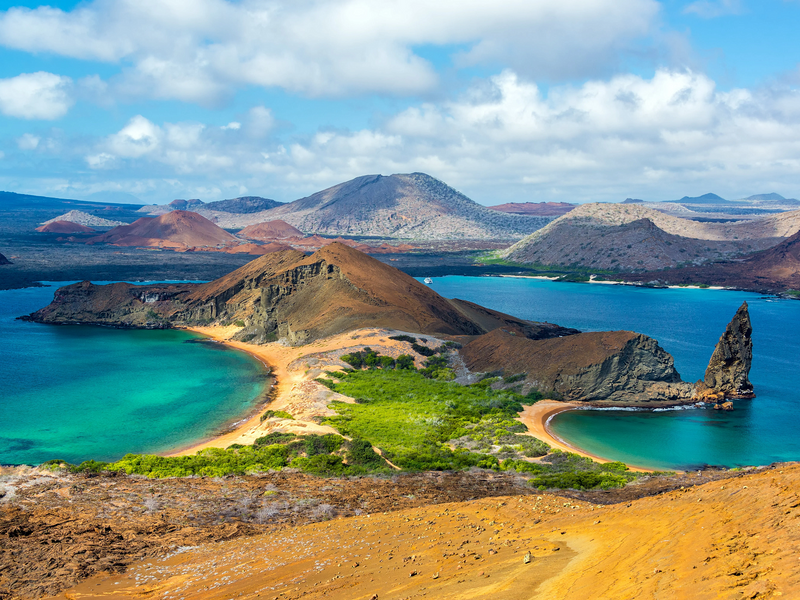 Scenic view of a volcanic island with turquoise waters and greenery; Galapagos Ecuador