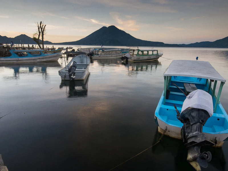 Boats on a dock with mountains in the background. Lake Atitlan, Guatemala.