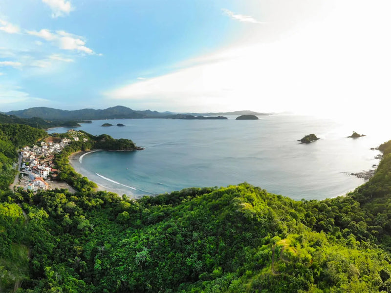 Scenic view of a coastal area with green hills and blue water; Las Catalinas, Costa Rica