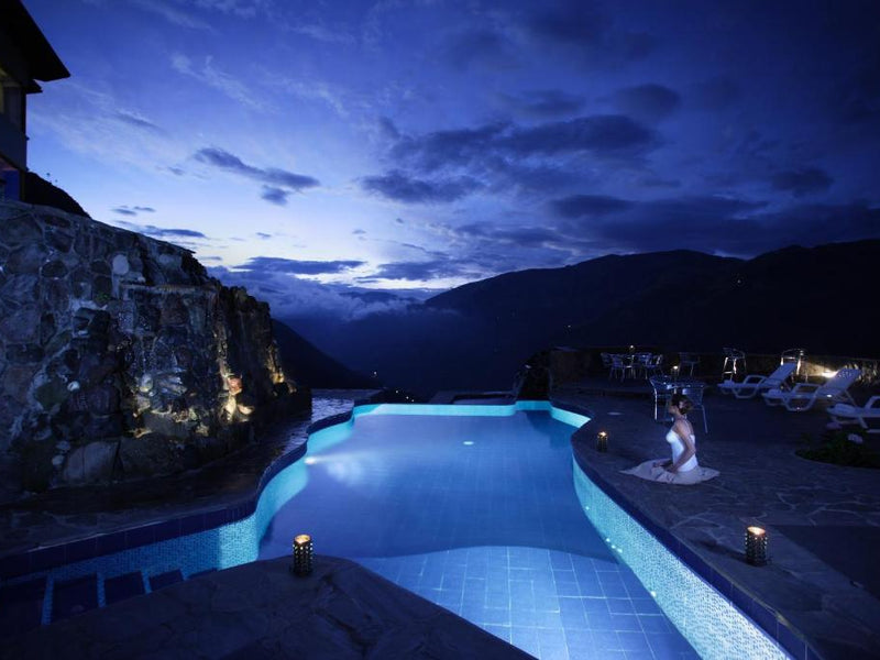 Luna Volcan pool night Banos Ecuador