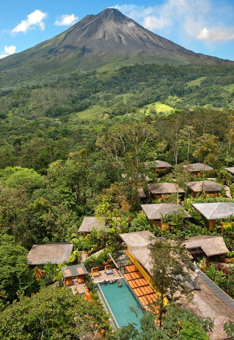 Villa complex with a pool surrounded by lush greenery and a volcano in the background; Nayara Springs Costa Rica Arenal La Fortuna