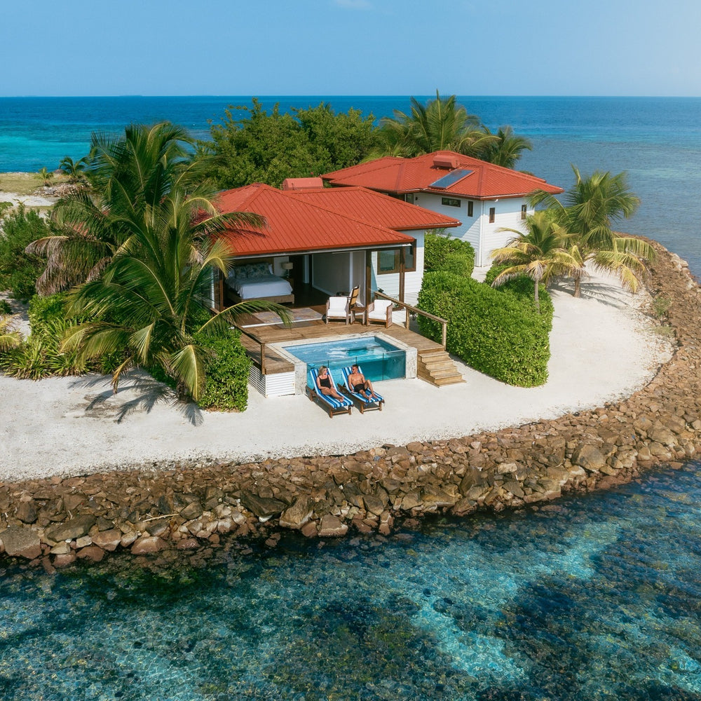 Luxury villa with a pool and red roof overlooking the ocean; Ray Caye Belize private island plunge pool