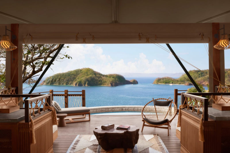 Outdoor deck with furniture and a scenic view of the ocean and island; Ritz Carleton Reserve Papagayo Costa Rica luxury resort