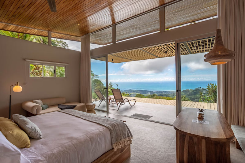 Modern bedroom with ocean view and outdoor seating area; Vista Celestial Costa Rica private plunge pool resort