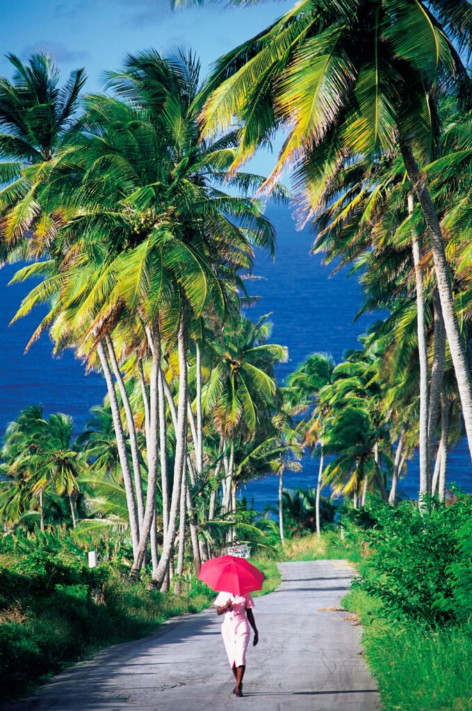 Woman with parasol walking in Barbados