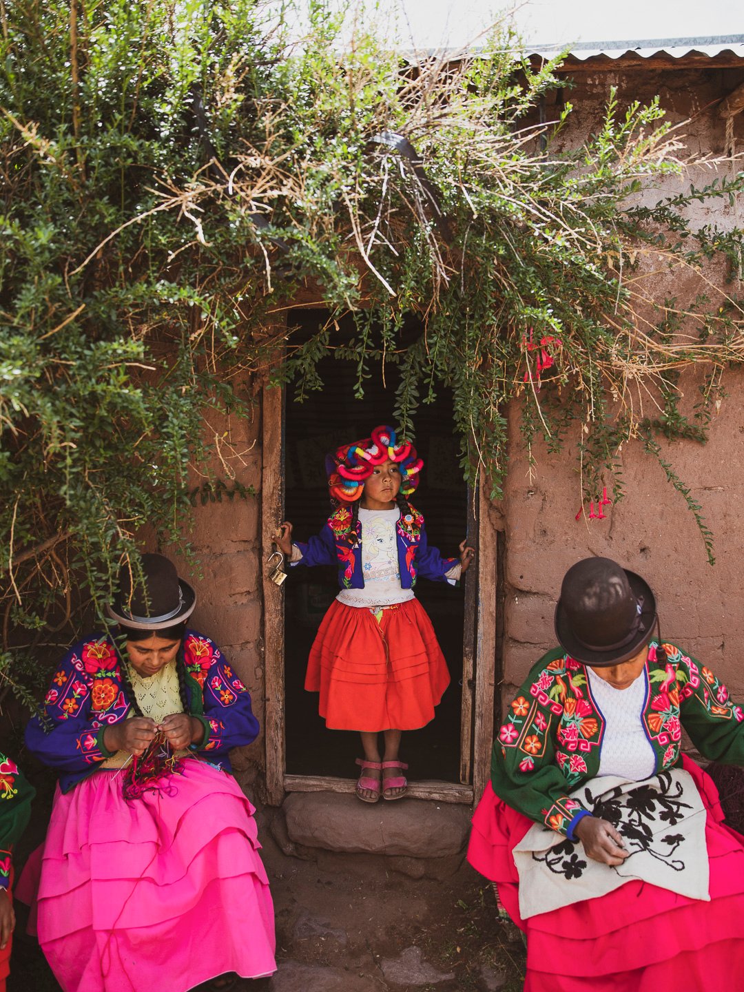 Titilaka children & local women embroidering in traditional dress
