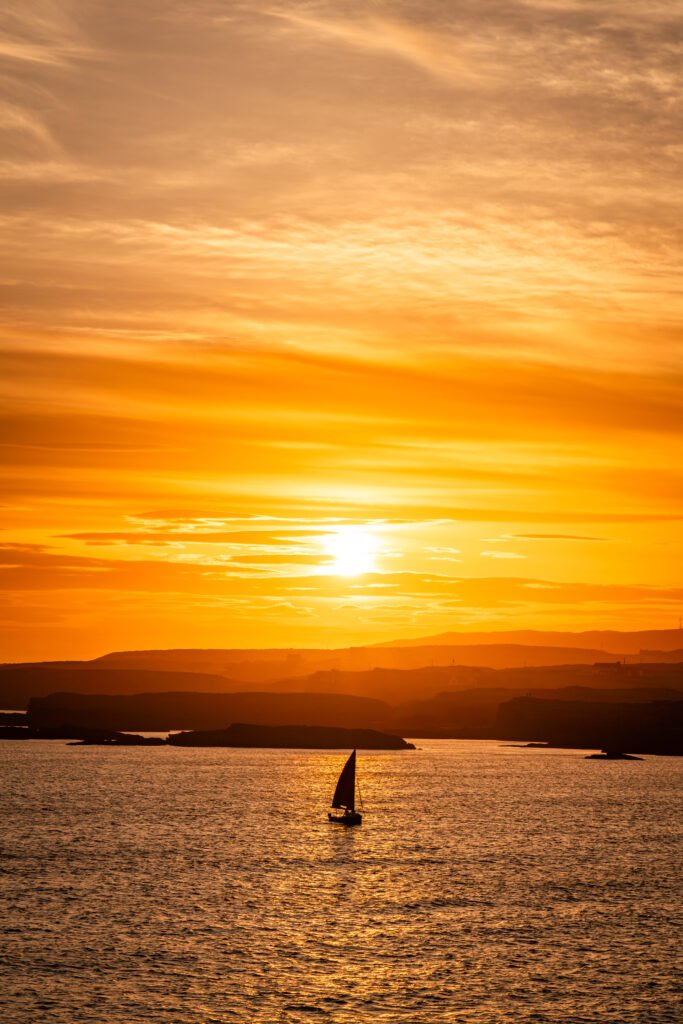 Sail at sunset with champagne in hand