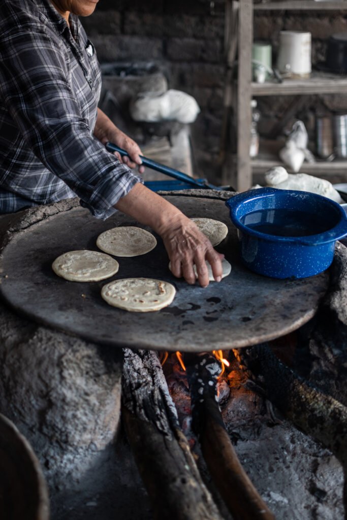 Mexican woman making a corn tortillas in a traditional way 